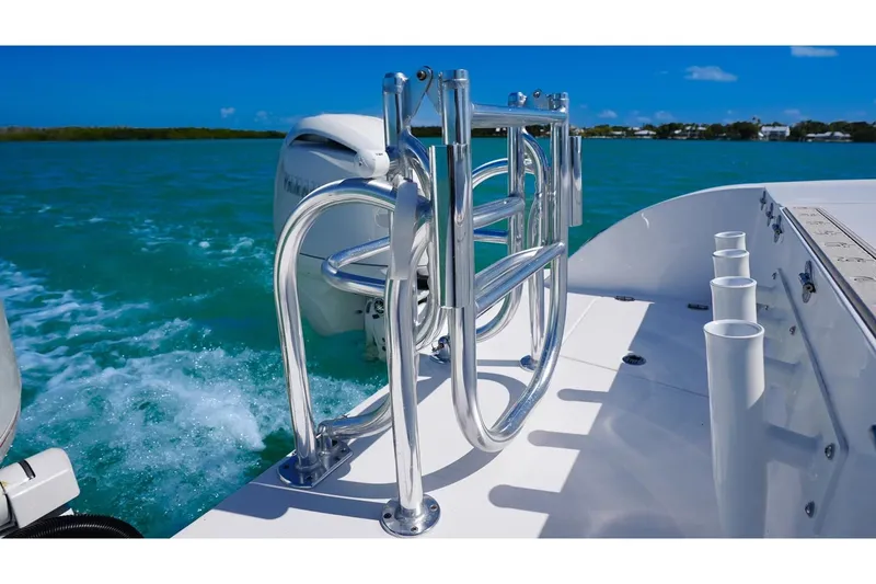 Slide: The Image of Twin Vee 240 GFX2 CC 2026 on blue water with stainless steel features. - 14