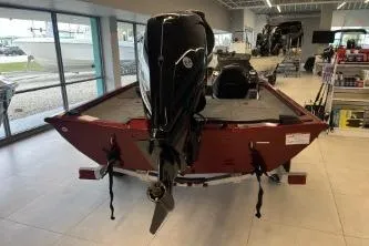 Slide: The Image of 2026 Crestliner XF 179 boat displayed indoors, featuring a powerful outboard motor. - 6