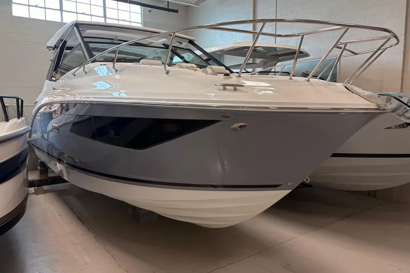 The Image of 2026 Sea Ray Sundancer 320 boat in showroom, showcasing sleek design and modern features. - 1