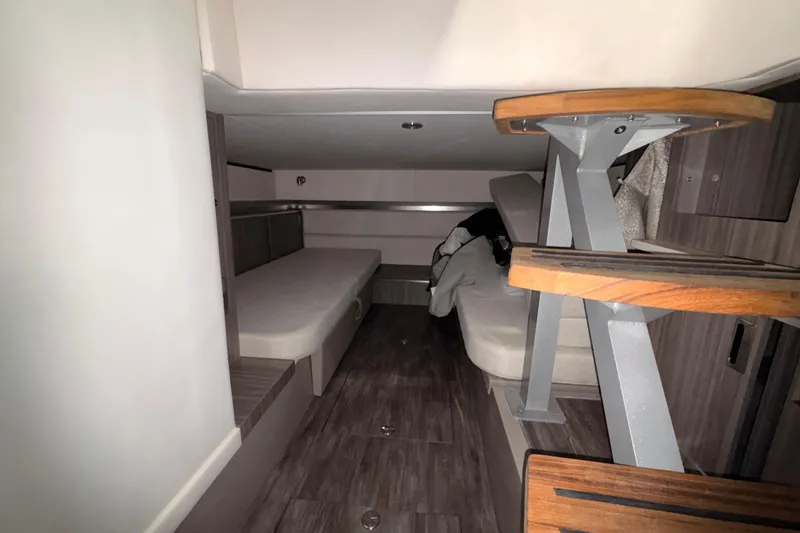 Slide: The Image of Interior cabin of 2026 Sea Ray Sundancer 320, featuring modern design and wooden accents. - 11