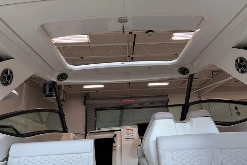 Slide: The Image of Interior view of 2026 Sea Ray Sundancer 320 boat with modern seating and speakers. - 12