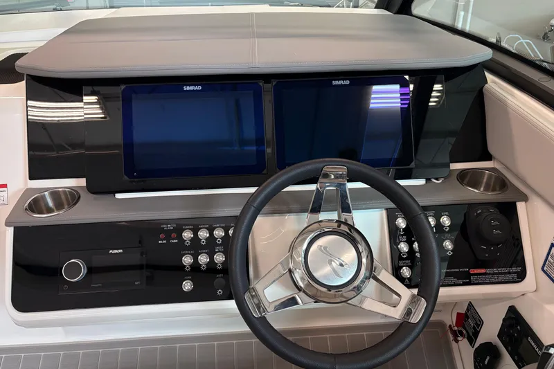 Slide: The Image of 2026 Sea Ray Sundancer 320 helm with dual Simrad displays and modern controls. - 13