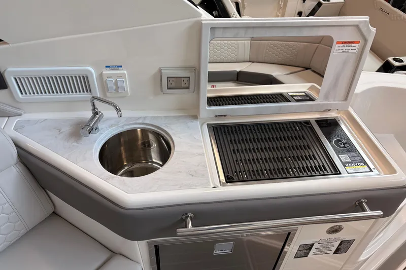 Slide: The Image of 2026 Sea Ray Sundancer 320 yacht kitchenette with sink and grill, featuring modern design. - 16