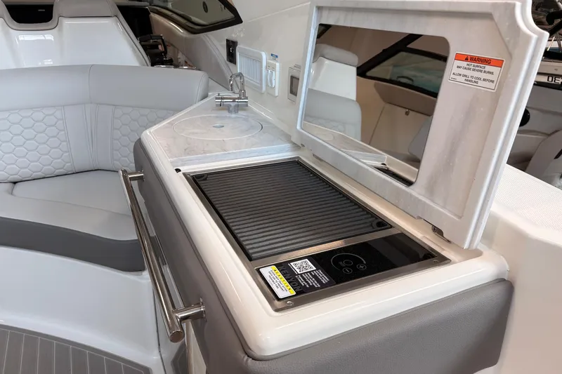 Slide: The Image of Luxurious 2026 Sea Ray Sundancer 320 yacht interior with grill and seating area. - 17