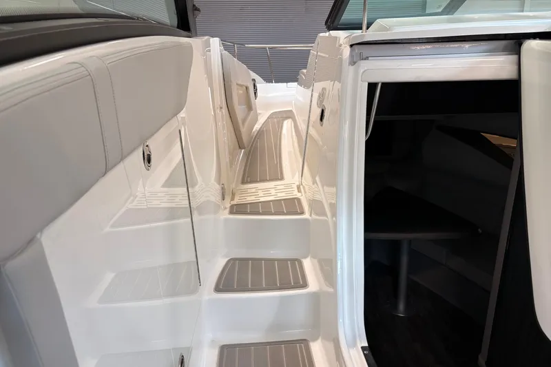 Slide: The Image of 2026 Sea Ray Sundancer 320 boat interior with sleek white steps and cabin entrance. - 20