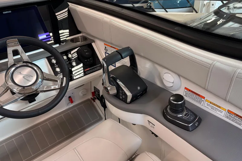 Slide: The Image of 2026 Sea Ray Sundancer 320 helm with modern controls and sleek steering wheel design. - 21