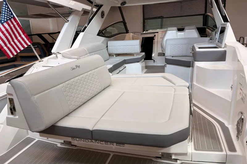 Slide: The Image of 2026 Sea Ray Sundancer 320 interior with luxurious seating and American flag. - 22