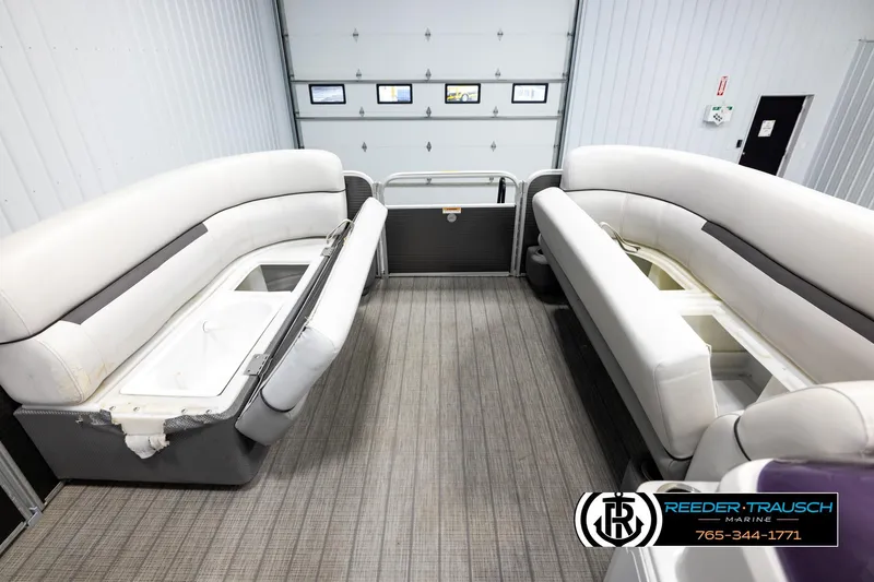 Slide: The Image of Interior of 2019 Sweetwater SW2086c pontoon boat with white seating and storage compartments. - 19