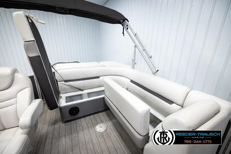 Slide: The Image of 2019 Sweetwater SW2086c boat interior with white seating and canopy, displayed at Reeder-Trausch Marine. - 21