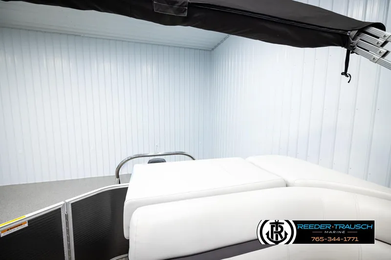 Slide: The Image of 2019 Sweetwater SW2086c pontoon boat interior with white seating, under a black canopy. - 22