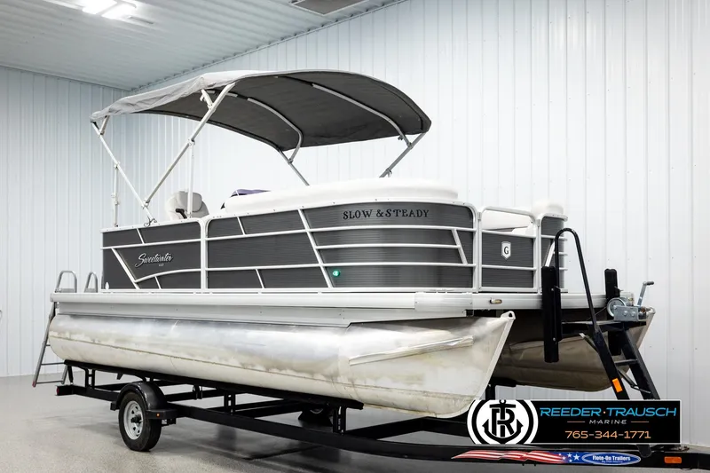 Slide: The Image of 2019 Sweetwater SW2086c pontoon boat on trailer in indoor storage facility. - 3