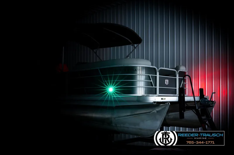 Slide: The Image of 2019 Sweetwater SW2086c pontoon boat with green light, displayed in a dimly lit setting. - 4