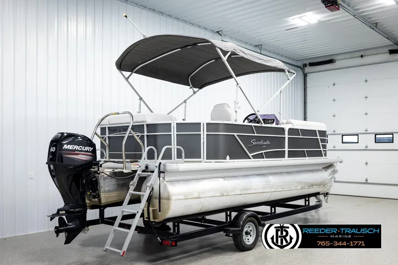 Slide: The Image of 2019 Sweetwater SW2086c pontoon boat with Mercury engine in a garage setting. - 6