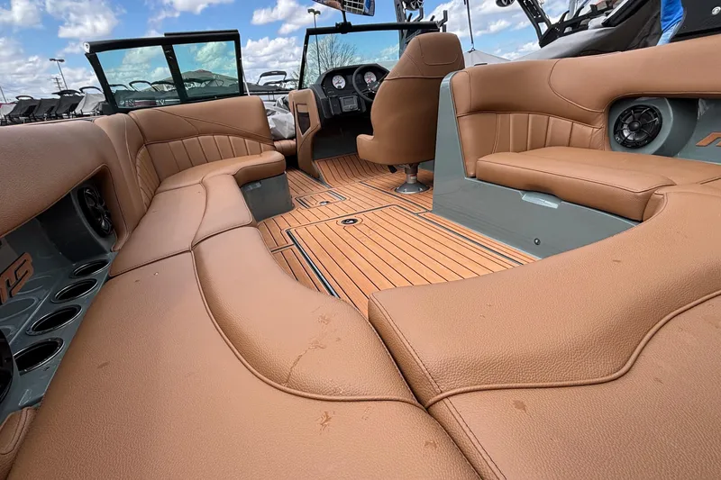 Slide: The Image of 2026 MB B52 23 Classic boat interior with tan leather seating and wood flooring. - 10