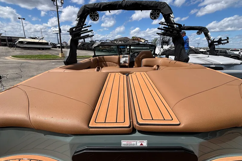 Slide: The Image of 2026 MB B52 23 Classic boat with tan interior, docked under a blue sky. - 13
