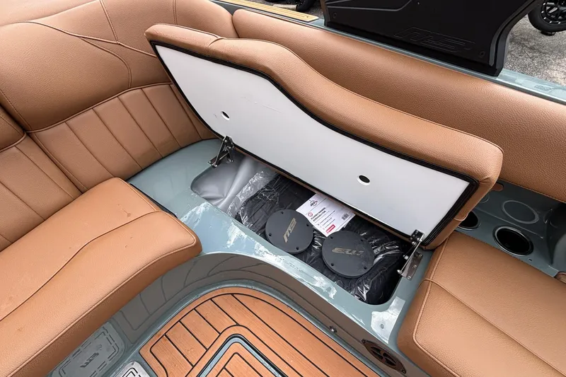 Slide: The Image of 2026 MB B52 23 Classic boat interior with tan seating and open storage compartment. - 20