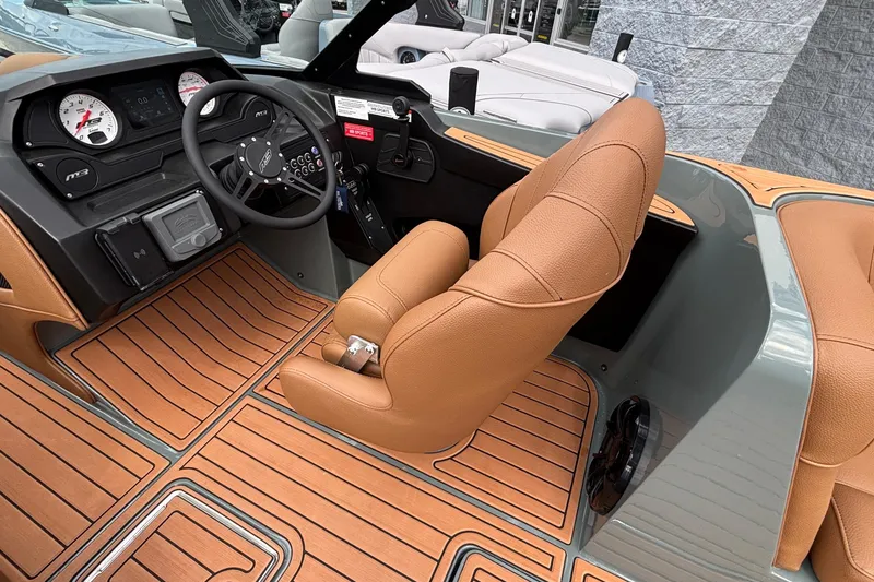 Slide: The Image of 2026 MB B52 23 Classic boat interior with tan leather seats and wood-patterned flooring. - 25