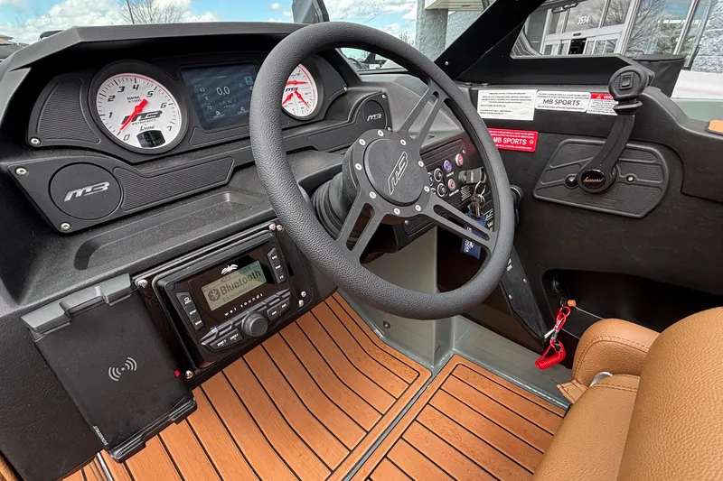Slide: The Image of 2026 MB B52 23 Classic boat dashboard with steering wheel, gauges, and Bluetooth stereo system. - 26