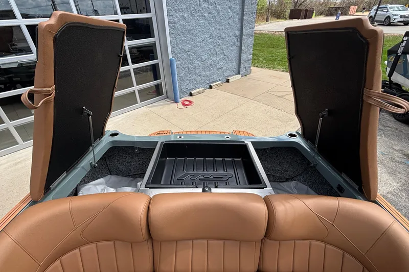 Slide: The Image of Open storage compartment of 2026 MB B52 23 Classic boat with brown leather seats. - 31