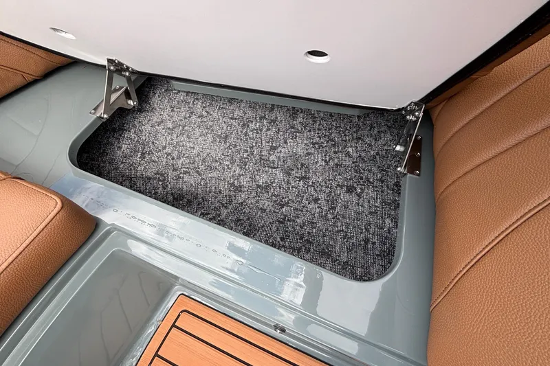 Slide: The Image of Interior storage compartment of 2026 MB B52 23 Classic boat with brown seating. - 39