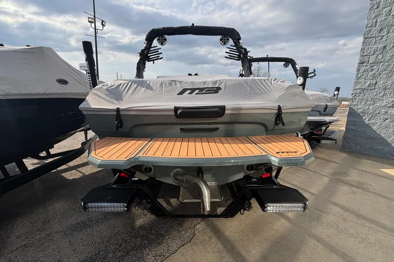 Slide: The Image of 2026 MB B52 23 Classic boat on trailer, covered, outside dealership under blue sky. - 4