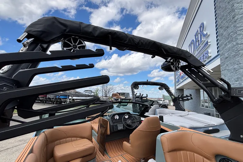 Slide: The Image of 2026 MB B52 23 Classic boat interior with tan seats and modern audio system. - 44