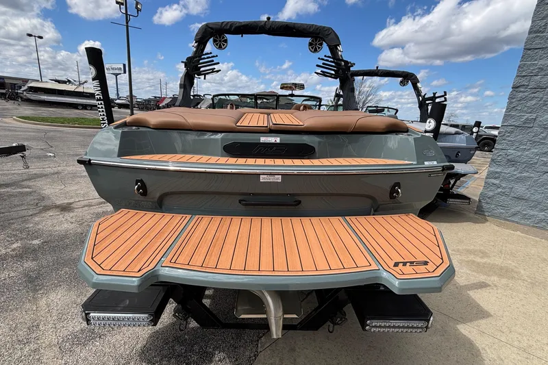 Slide: The Image of 2026 MB B52 23 Classic boat with teak deck, parked outdoors under blue sky. - 47