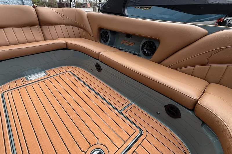 Slide: The Image of Luxurious interior of 2026 MB B52 23 Classic boat with tan seating and wood flooring. - 8