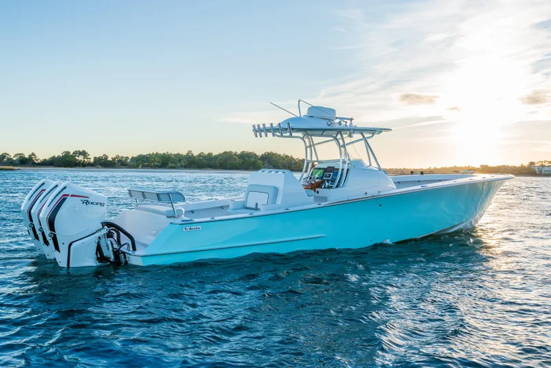 The Image of 2018 Tribute 37 boat on water at sunset with triple outboard engines. - 0
