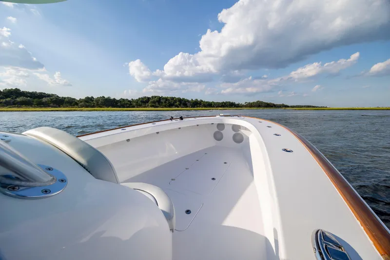 Slide: The Image of 2018 Tribute 37 boat on calm water under a blue sky with clouds. - 13