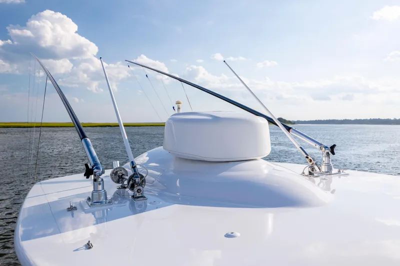 Slide: The Image of 2018 Tribute 37 boat with fishing rods on deck, calm water, and blue sky. - 17