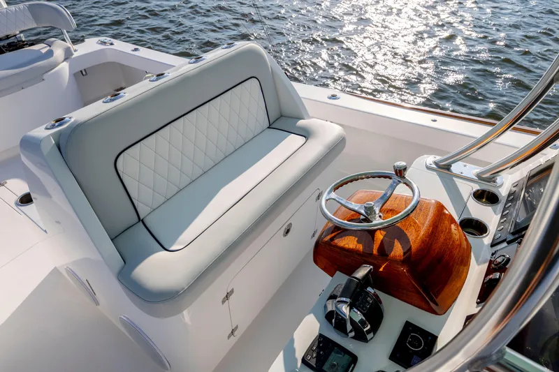 Slide: The Image of Luxurious 2018 Tribute 37 boat interior with elegant seating and polished steering wheel. - 18
