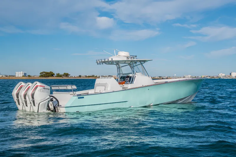 Slide: The Image of 2018 Tribute 37 boat with triple engines on open water. - 2