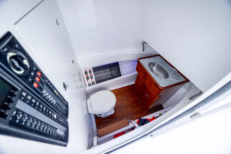 Slide: The Image of Compact boat bathroom with sink, toilet, and control panel in 2018 Tribute 37 model. - 5