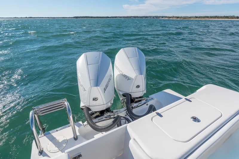 Slide: The Image of 2023 Contender 28 Sport boat with dual Mercury outboard engines on open water. - 12