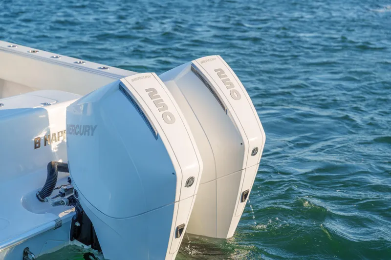 Slide: The Image of 2023 Contender 28 Sport boat with dual Mercury 250 outboard engines on water. - 16