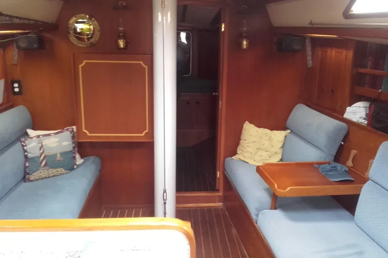 The Image of Interior of a 1980 Nordic 44 sailboat with cozy seating and wooden finishes. - 0