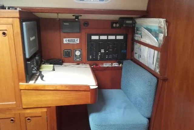 Slide: The Image of Navigation station in a 1980 Nordic 44 sailboat with control panel and seating. - 10