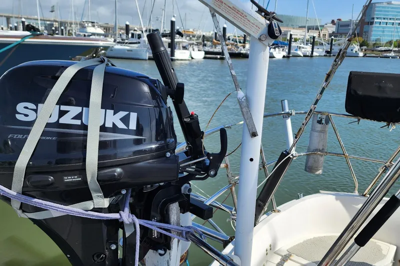 Slide: The Image of Outboard motor on a 1980 Nordic 44 sailboat docked in a marina. - 11