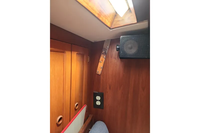 Slide: The Image of Interior of 1980 Nordic 44 sailboat with wood paneling, speaker, and skylight. - 13