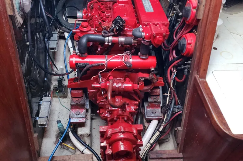 Slide: The Image of Red engine inside a Nordic 44 sailboat, model year 1980, with visible wiring and components. - 17