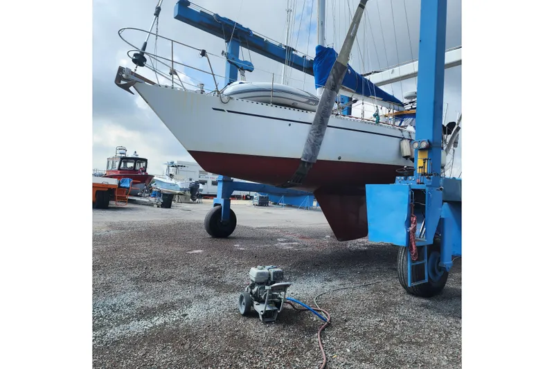 Slide: The Image of Sailboat Nordic 44 from 1980 in dry dock, supported by a blue lift. - 7