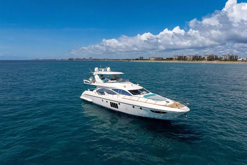 Slide: The Image of Luxurious 2011 Azimut 70 yacht cruising on open sea under clear blue sky. - 109