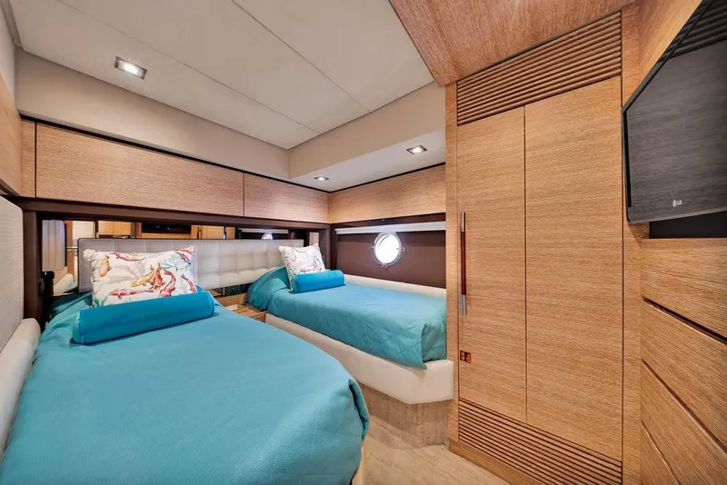 Slide: The Image of Luxurious 2011 Azimut 70 yacht cabin with twin beds and modern wood paneling. - 53