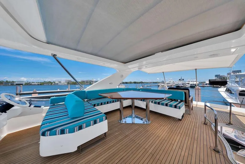 Slide: The Image of Luxurious 2011 Azimut 70 yacht deck with stylish seating and scenic waterfront view. - 98