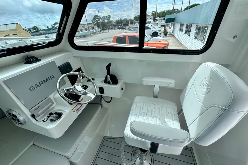Slide: The Image of Interior of 2026 Parker 247 Explorer boat with Garmin navigation system and white seating. - 10