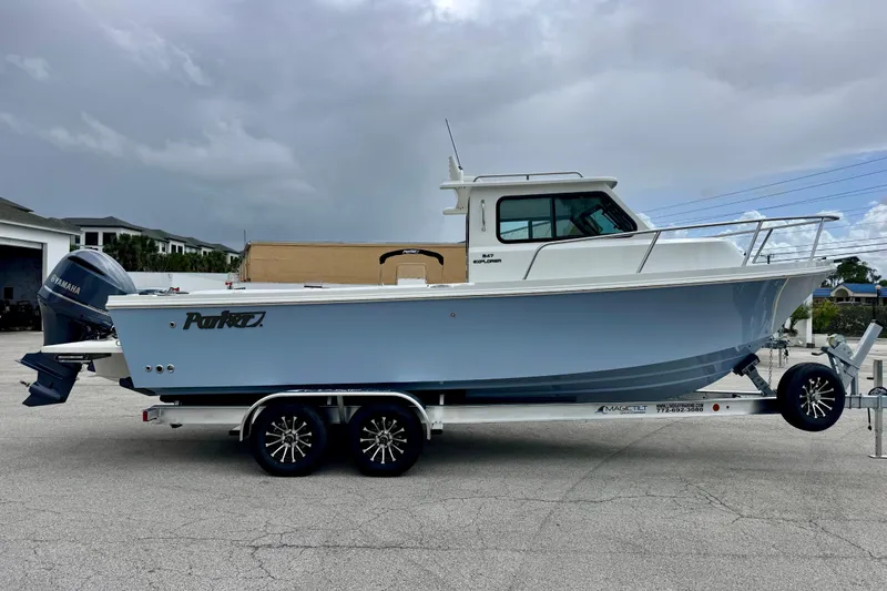 Slide: The Image of 2026 Parker 247 Explorer boat on trailer, featuring sleek design and Yamaha outboard motor. - 6