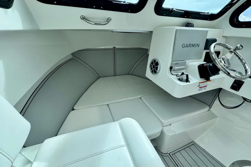 Slide: The Image of Interior of 2026 Parker 247 Explorer boat with Garmin navigation system and cushioned seating. - 9