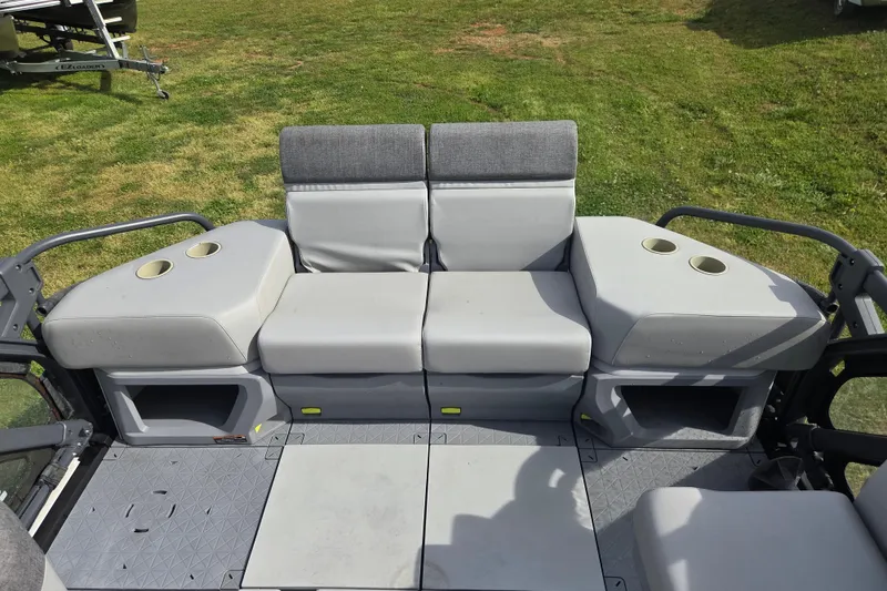 Slide: The Image of 2024 Sea-Doo Switch Cruise 21 seating area with cup holders on grassy background. - 14