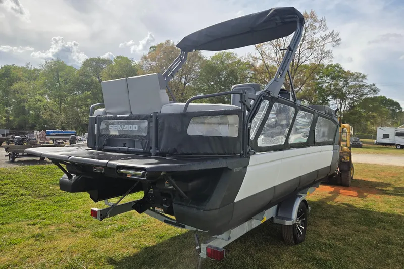 Slide: The Image of 2024 Sea-Doo Switch Cruise 21 pontoon boat on trailer, parked outdoors. - 4
